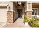 Inviting front entrance featuring stone accents, a decorative wreath, and a well-manicured landscape at 3274 E Isaiah Ct, Gilbert, AZ 85298