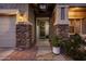 Inviting front entrance featuring stone accents, potted plants, and a decorative wreath at 3274 E Isaiah Ct, Gilbert, AZ 85298