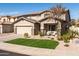 Beautiful front exterior with a well-manicured lawn, stone accents, and a cozy front porch seating area at 3274 E Isaiah Ct, Gilbert, AZ 85298