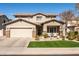 Charming two-story home showcasing a well-manicured lawn and a welcoming front porch at 3274 E Isaiah Ct, Gilbert, AZ 85298