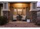 Relaxing front porch area with comfortable seating and decorative stone pillars at 3274 E Isaiah Ct, Gilbert, AZ 85298