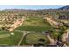 Aerial view of lush golf course, showcasing manicured greens, sand traps, and mature landscaping within a residential community at 3274 E Isaiah Ct, Gilbert, AZ 85298