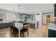 Open-concept kitchen with large dining table, stainless steel appliances, and seamless connection to the home's entryway at 3274 E Isaiah Ct, Gilbert, AZ 85298