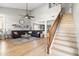 Bright and spacious living room showcasing wood floors, vaulted ceiling, and a staircase at 3274 E Isaiah Ct, Gilbert, AZ 85298