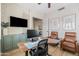 Well-lit home office featuring built-in storage, modern desk setup, and cozy leather chairs at 3274 E Isaiah Ct, Gilbert, AZ 85298