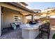 Outdoor kitchen under a covered patio featuring a built-in bar, ample seating, and a cozy lounge area, ideal for entertaining at 3274 E Isaiah Ct, Gilbert, AZ 85298