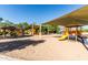 Gathering-friendly playground with colorful slides and climbing equipment under shaded canopies in the community at 3274 E Isaiah Ct, Gilbert, AZ 85298