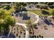 Aerial view of a playground featuring shade structures, swings, and picnic spots in the community park at 3274 E Isaiah Ct, Gilbert, AZ 85298