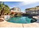 Backyard pool featuring a rock waterfall, lush greenery, and a beautiful patio area, ideal for relaxation at 3274 E Isaiah Ct, Gilbert, AZ 85298