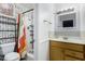 Bright bathroom with white tiles, a colorful shower curtain, and a modern sink and vanity at 4022 W Kaler Dr, Phoenix, AZ 85051