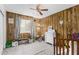 Wood paneled bedroom offering a window for natural light, neutral carpet and lots of playing space at 4022 W Kaler Dr, Phoenix, AZ 85051