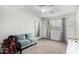 This bedroom features an abundance of natural light, a comfy love seat and soft carpet at 4022 W Kaler Dr, Phoenix, AZ 85051