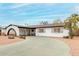 Charming home featuring an arched carport and minimalist landscaping at 4022 W Kaler Dr, Phoenix, AZ 85051