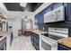 Modern kitchen and dining area with stainless steel appliances and sleek butcher block countertops at 4022 W Kaler Dr, Phoenix, AZ 85051