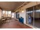 Enclosed patio featuring red floors, neutral walls, and furniture for entertaining and relaxation at 4022 W Kaler Dr, Phoenix, AZ 85051