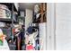 Overstuffed storage closet with shelves, water heater and assorted items at 4022 W Kaler Dr, Phoenix, AZ 85051