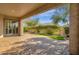 View of a backyard with a covered patio, lush landscaping, and grass, creating a private retreat at 4221 E Sourwood Dr, Gilbert, AZ 85298