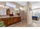 Bright main bathroom featuring double sinks, a walk-in shower, and neutral colored tile flooring at 4221 E Sourwood Dr, Gilbert, AZ 85298