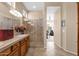 Bright main bathroom featuring double sinks, a walk-in shower, and access to the main bedroom at 4221 E Sourwood Dr, Gilbert, AZ 85298