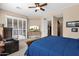 View of main bedroom featuring a ceiling fan, neutral color palette, and sliding door to the outdoor patio at 4221 E Sourwood Dr, Gilbert, AZ 85298