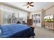 Spacious main bedroom features a ceiling fan, entertainment center and sliding doors to the outdoor patio at 4221 E Sourwood Dr, Gilbert, AZ 85298