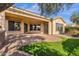 A covered patio enhances outdoor living, with brick pavers, a lawn, and access to the home's interior at 4221 E Sourwood Dr, Gilbert, AZ 85298