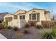 Attractive home exterior with xeriscaping, neutral stucco and green shutters on a sunny day at 4455 S Matter --, Mesa, AZ 85212