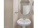 Elegant powder room features a pedestal sink and oval mirror at 44983 W Sage Brush Dr, Maricopa, AZ 85139