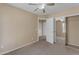 A bedroom with carpet, ceiling fan, open closet and open door at 44983 W Sage Brush Dr, Maricopa, AZ 85139