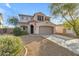 Inviting two-story home featuring a well-manicured front yard, a large driveway, and an attached two-car garage at 44983 W Sage Brush Dr, Maricopa, AZ 85139