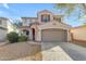 Charming two-story home with a neutral color scheme, complemented by a spacious driveway and well-maintained landscaping at 44983 W Sage Brush Dr, Maricopa, AZ 85139