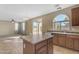 Well-appointed kitchen with a central island and stainless steel dishwasher at 44983 W Sage Brush Dr, Maricopa, AZ 85139