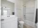 All-white bathroom with tiled shower and tub combo, modern fixtures, and neutral wall color at 47558 W Mellen Ln, Maricopa, AZ 85139