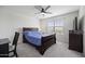 Comfortable bedroom featuring a ceiling fan, bed and view from the window at 47558 W Mellen Ln, Maricopa, AZ 85139