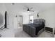 A primary bedroom with a gray bed frame and ceiling fan at 47558 W Mellen Ln, Maricopa, AZ 85139