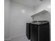 This laundry room features modern front load washer and dryer at 47558 W Mellen Ln, Maricopa, AZ 85139