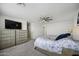 Bright main bedroom with ceiling fan, ample dresser storage and natural light at 47558 W Mellen Ln, Maricopa, AZ 85139