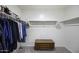 Spacious walk-in closet with ample storage space, rods, shelving, and a dresser at 47558 W Mellen Ln, Maricopa, AZ 85139