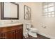 Bathroom featuring granite counters, dark wood cabinetry, and a glass block window for privacy at 4822 S Gold Canyon Dr, Gold Canyon, AZ 85118