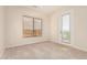 Bright bedroom with tan carpet, a window with mountain views, and a door to the balcony at 4822 S Gold Canyon Dr, Gold Canyon, AZ 85118