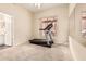 Neutral bedroom featuring a treadmill, ceiling fan, and window with views, great for a home gym at 4822 S Gold Canyon Dr, Gold Canyon, AZ 85118