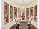 Dining room with crystal chandelier, wood table, chairs, and large picture windows overlooking landscaping at 4822 S Gold Canyon Dr, Gold Canyon, AZ 85118