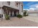 A striking stucco house showing a charming porch, lush cacti, and a side-entry garage at 4822 S Gold Canyon Dr, Gold Canyon, AZ 85118