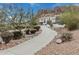 Beautiful stucco home with a winding driveway and desert landscaping, nestled in a mountainous landscape at 4822 S Gold Canyon Dr, Gold Canyon, AZ 85118