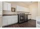 Laundry room with modern washer and dryer, white cabinets, and dark wood-look floors at 4822 S Gold Canyon Dr, Gold Canyon, AZ 85118