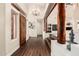 Open-concept living room with wood flooring, timber beam, fireplace, and large windows at 4822 S Gold Canyon Dr, Gold Canyon, AZ 85118