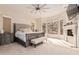 Main bedroom with fireplace, king-sized bed, neutral carpet, and windows with desert views at 4822 S Gold Canyon Dr, Gold Canyon, AZ 85118