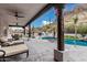 An outdoor space with a pool and seating under a shaded patio at 4822 S Gold Canyon Dr, Gold Canyon, AZ 85118