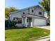 Charming two-story home with fresh green grass, lush landscaping, and a welcoming entrance at 5021 W Chicago N Cir, Chandler, AZ 85226