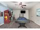 Spacious game room featuring a pool table, TV, and vintage arcade games for endless entertainment at 5021 W Chicago N Cir, Chandler, AZ 85226